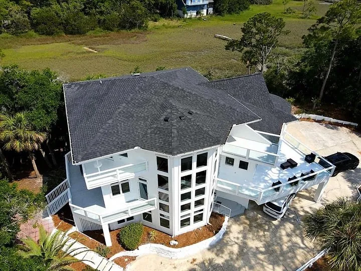 Aerial view of a large coastal home exterior freshly repainted
